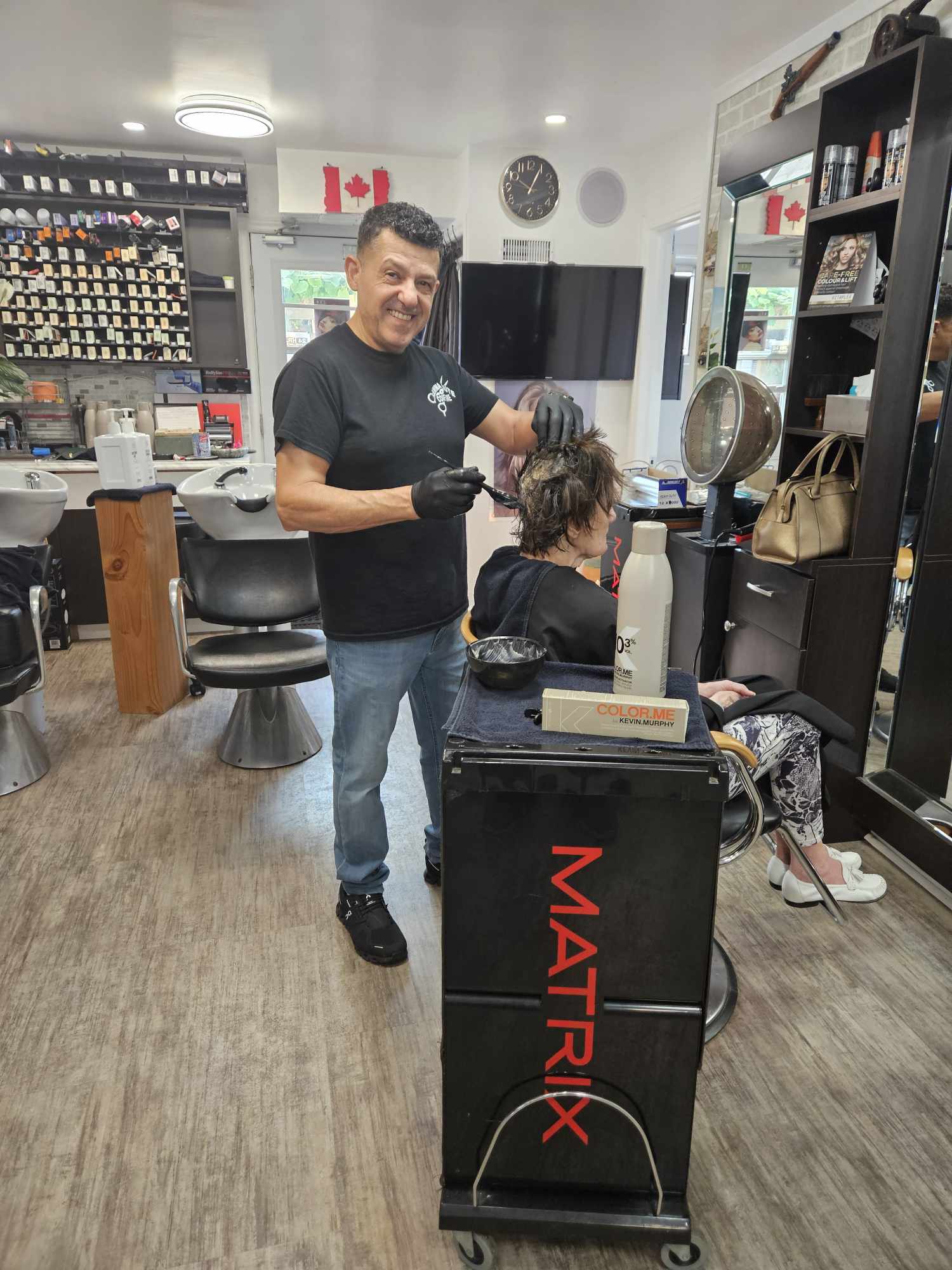Sawma stylist coloring a client's hair inside the salon